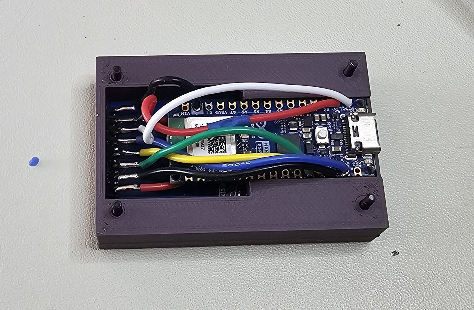 Arduino Nano ESP32 seated in the enclosure's back shell, wired to the display header with coloured silicone hookup wire.